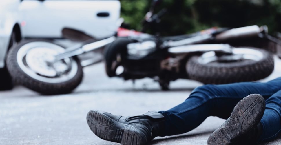 Victim of a motorbike accident lying on the street unconscious